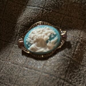 Elegant Cameo Brooch with Blue and Gold Accents
Box 1